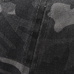 Detailed close-up of heavy-duty camo twill fabric and reinforced double stitching on baseball cap