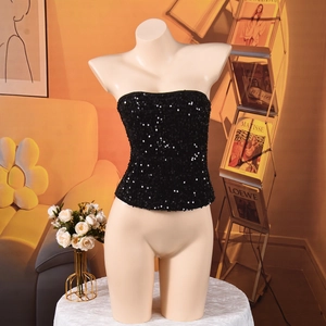 Detail shot of black sequin cropped tube top showing shimmering texture and zipper design