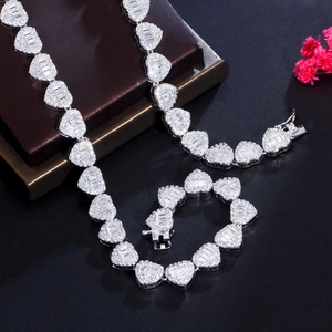 Macro detail of iced-out heart link necklace and bracelet set with cubic zirconia stones
