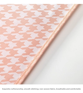 Detail of pink houndstooth non-woven fabric with clean stitching on garment cover