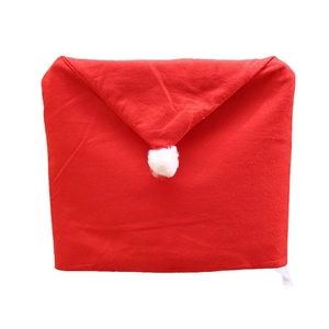 Red Santa hat chair cover with white pompom for Christmas dining room decoration