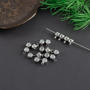 Macro view of silver-plated non-slip stopper beads with silicone core and hanging loops