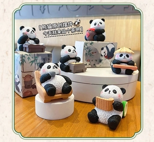 Set of six cute resin panda figurines in traditional poses on a wooden display table