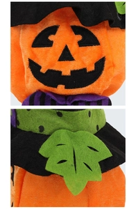 Close-up of soft velvet pumpkin Halloween gift bag with black wizard hat and leaf details
