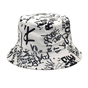 Close-up of the graffiti print and reinforced stitching on the white cotton bucket hat