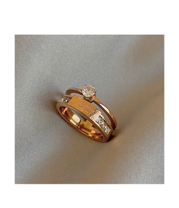 Macro view of rose gold double-layer rings with central Love Forever engraved plaque