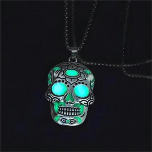 Close-up of luminous Mexican sugar skull pendant with green glowing hollow eyes