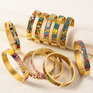 Detail of 18K gold plated stainless steel bangles with colorful enamel art patterns