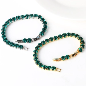 Detail of 6mm round green zircon tennis bracelets in silver and gold-tone finish