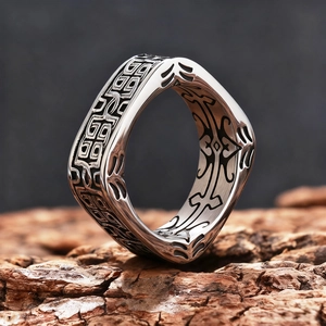 Men's wide square retro ring with ancient beast patterns on dark wood bark surface