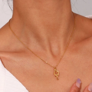 Close-up of a person wearing a gold 18K plated stainless steel lava pendant necklace