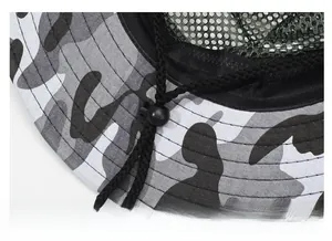 Detail of adjustable windproof drawstring and green breathable mesh lining on camo hat