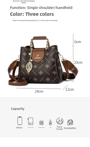 Detail view of brown patterned handbag with leaf charm and removable shoulder strap