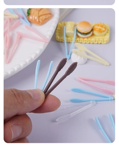 Close-up of colorful mini tweezers for DIY crafts and dollhouse food accessories