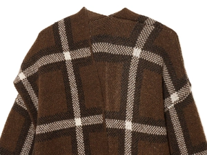 Close-up of deep brown plaid knit cardigan showing thick wool texture and vintage patterns