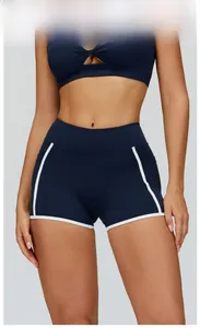 Detail view of high-waist abyss blue yoga shorts with athletic white contrast piping