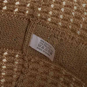 Macro shot of French straw hat showing 65% cotton blend label and hollow knit texture