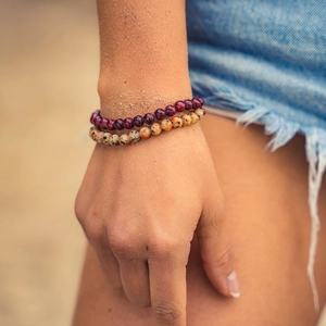 Natural crystal agate tiger eye beaded bracelet set on a sunny beach background