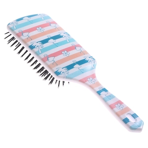 Detail of large paddle brush featuring tropical flamingo pattern and air cushion bristles