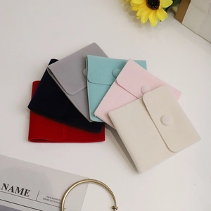 Pink velvet jewelry pouches with snap buttons in multiple colors for storage and gifts