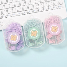 Detailed view of pastel purple, green, and pink paper clips and binder clips in clear cases