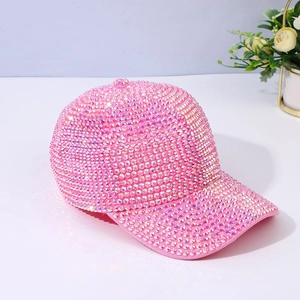 Sparkling hot pink rhinestone baseball cap with full crystal embellishment on white surface