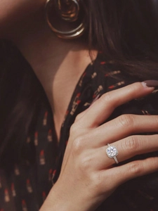 Close-up of S925 sterling silver halo moissanite ring worn elegantly on a model finger