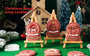 Christmas cookies on mini wooden easels featuring Santa, reindeer and tree icing patterns