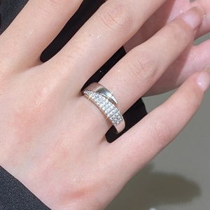 Close-up of silver open ring featuring three rows of pave-set cubic zirconia stones