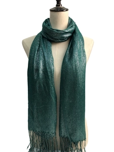 Close-up of green metallic scarf featuring elegant shimmering fabric and fringe tassels