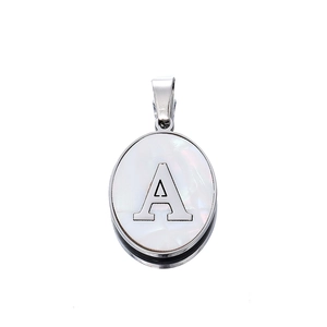 Macro view of oval stainless steel pendant with white mother-of-pearl and silver letter A