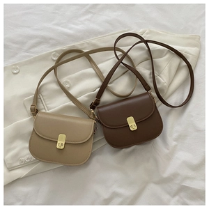 Detail showing vintage saddle bags in light and dark brown PU leather with metal clasp