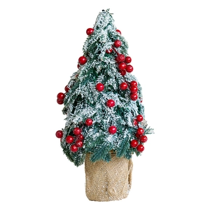 Mini snowy Christmas tree centerpiece with red berries and a rustic burlap base