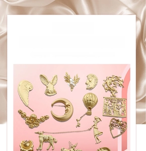 Baroque style gold alloy brooches with feather, moon, and hot air balloon motifs