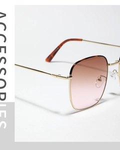 Detail of gold metal glasses frame with gradient lenses and tortoiseshell temple tips