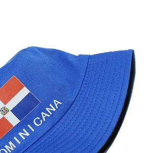 Detailed close-up of Dominican flag embroidery and DOMINICANA text on blue bucket hat