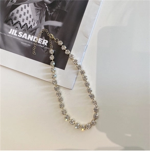Detail of gold choker necklace with pavé crystal rhinestones and lobster clasp