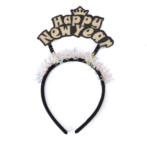 Detail of Happy New Year headband with gold crown and colorful tinsel party decoration