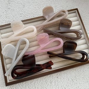 Detailed overhead view of assorted high-quality hair claws on a velvet jewelry tray
