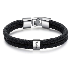 Detail of personalized black braided leather bracelet with engraved name Nadine on silver charm