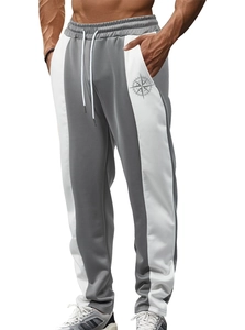 Men's grey and white contrast patchwork joggers with drawstring waist and compass logo