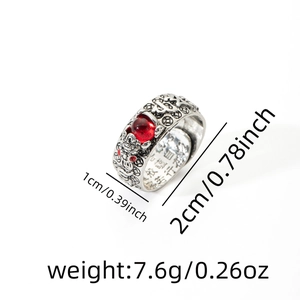 Detailed view of vintage silver ring with red garnet stone and engraved scripture inside