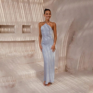 Elegant blue halter satin maxi dress with backless design for women in outdoor setting