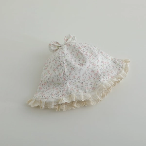 Close-up of baby sun hat featuring pink floral patterns and delicate lace trim edges