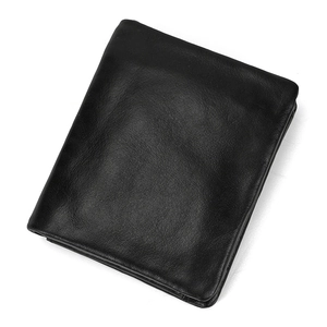 Detailed view of genuine leather texture on a minimalist black bi-fold wallet for men