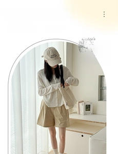 Close-up of light gray breathable cotton socks paired with casual shorts and beige top