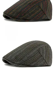 Detail view of winter wool flat caps in striped and black grey herringbone tweed fabric