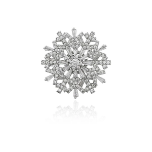 Elegant rotating snowflake brooch with clear zircon crystals on white background