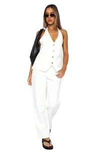 Detail of white V-neck suit vest with metal buttons and matching wide-leg trousers