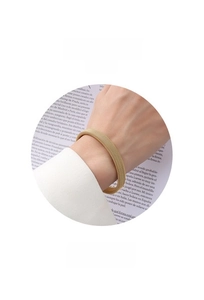 Detail of golden mesh texture bangle with Z223 model engraving in minimalist style